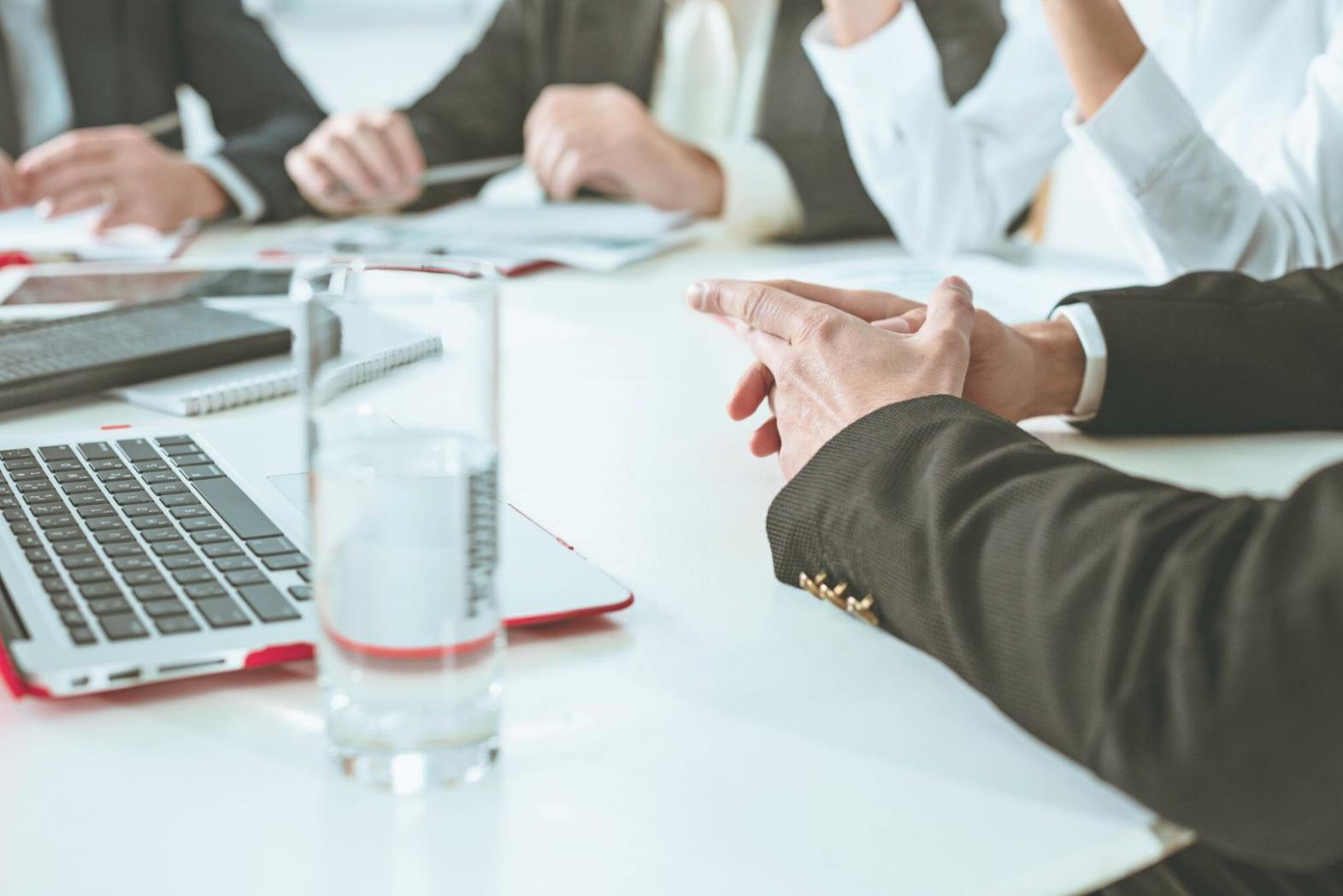 Reunión de trabajo con documentos financieros y calculadora sobre mesa de oficina